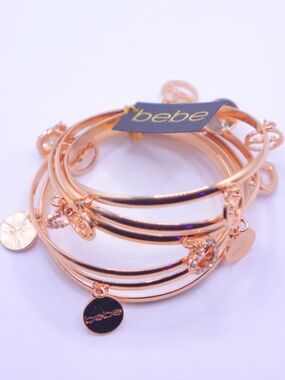 bebe Gold tone Multi-Charm Bangle Set